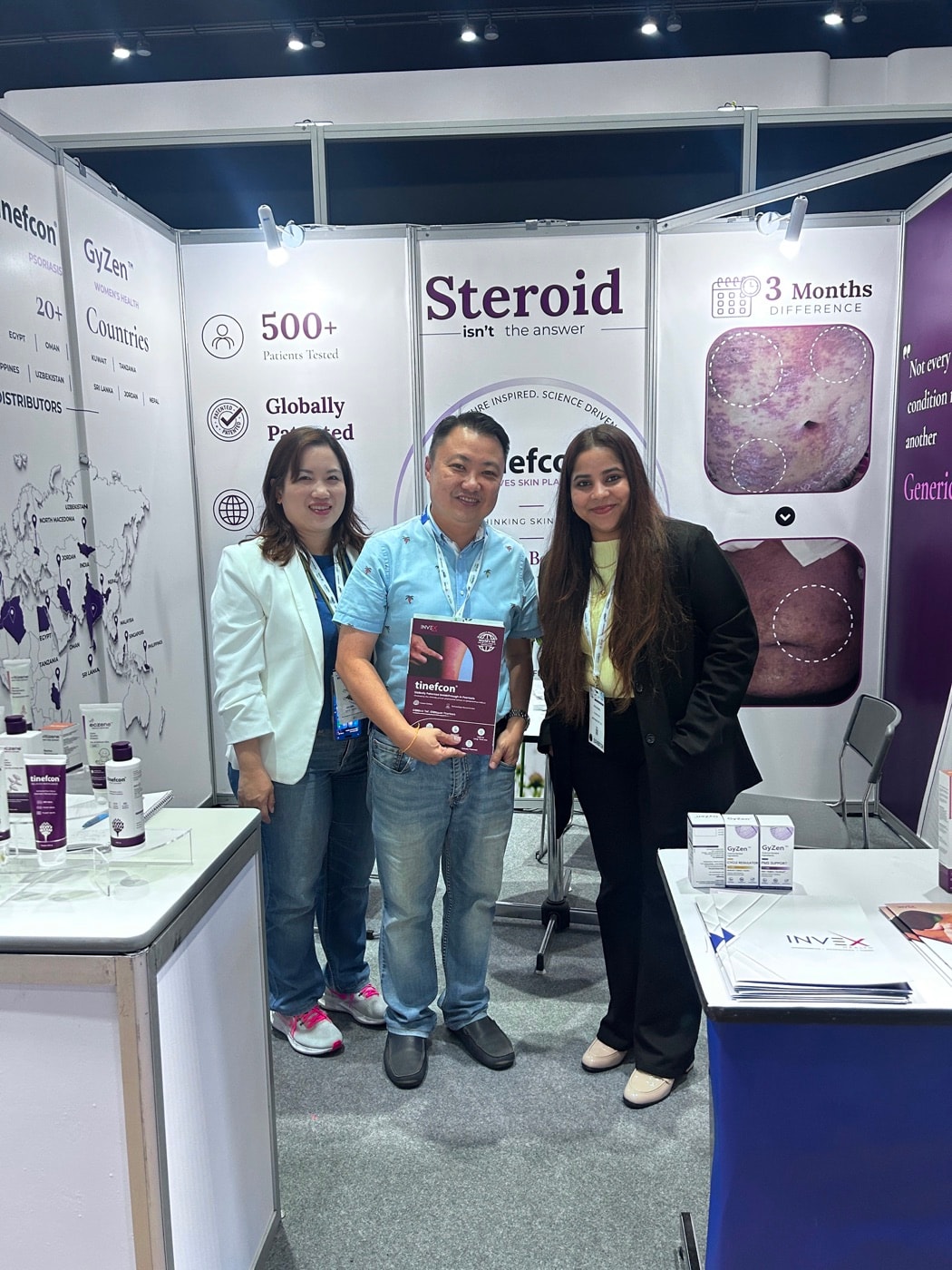 Colleagues at the Invex Health stand at CPHI Bangkok, beside its product panels
