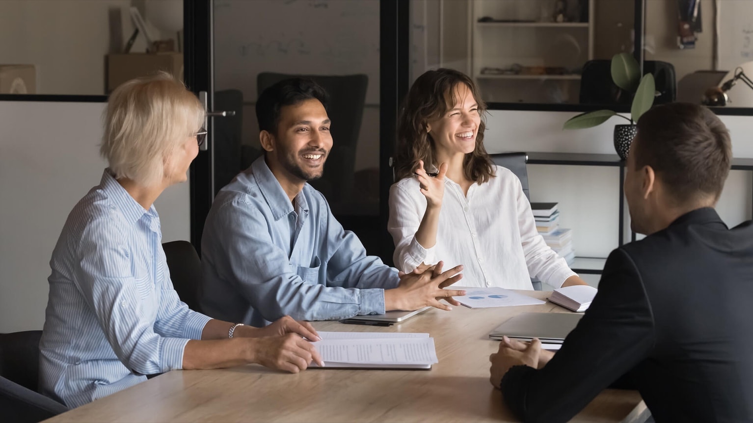 Colleagues talking around a meeting table